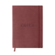 A burgundy PU cover notebook featuring an embossed logo and a matching elastic band closure.