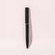 A black ballpoint pen with a mirror finish, featuring a sleek design and a cap. It includes a logo.