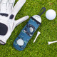 A blue golf ball holder with a golf-themed design, featuring a golf glove, ball, and tee on grass.