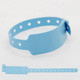 A light blue vinyl wristband with holes for adjustable fitting. It has a tab for securing the band.