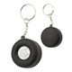A black tyre-shaped key ring with a silver centre, featuring a metal chain and keyring attachment.