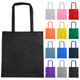 A black non-woven reusable grocery bag with long handles, surrounded by bags in various colours.