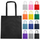 A black non-woven reusable grocery bag with long handles, surrounded by various coloured bags.