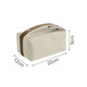 A portable canvas cosmetic bag in cream with brown accents, featuring a zipper closure and measuring 22cm x 12cm x 9cm.