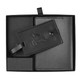 A black travel gift set featuring a luggage tag and a passport holder, presented in a sleek box with branding.