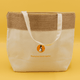 A jute and cotton cooler bag in cream and tan, featuring handles and a circular logo.