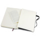A large, soft cover Moleskine notebook in black with an open page revealing a blank inner page.