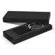 A square black key ring with a textured surface, presented in a sleek black gift box.