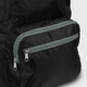 A black foldable backpack with a grey zippered pocket. The material appears lightweight and durable, with a sleek design.