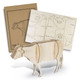 A wooden model of a cow in natural wood tones, accompanied by packaging with cut-out designs.