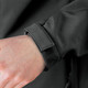 A close-up of a black soft shell jacket cuff with a Velcro strap. The fabric appears smooth and sleek.