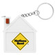 A white tape measure shaped like a house with a keychain attachment, featuring a logo on the front.