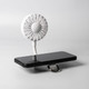 A white rechargeable fan with a flexible neck attached to a black smartphone stand. The fan features a circular design and a logo.