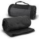 A rolled black fleece blanket with a strap lies beside an unrolled version, showcasing its soft texture.