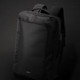 A black Swiss Peak convertible travel backpack with adjustable shoulder straps and a front compartment, featuring a logo.