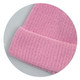 A pink brushed kids beanie with a textured, ribbed cuff and soft fabric. It features a logo on the tag.