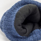 A blue beanie with a soft black lining, featuring a textured knit pattern and a logo.