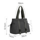A lightweight tote bag in dark grey with adjustable yoga mat straps and multiple pockets. It has a logo on the front.