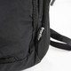 A black daypack with mesh detailing and a logo on the side. The straps are partially visible.