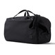 A black duffel bag with handles and an adjustable strap, featuring a small logo on the side.