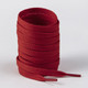 A roll of red shoelaces with tapered ends, neatly stacked and ready for use, featuring a logo.