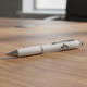 A white stylus pen with a silver clip resting on a wooden table, featuring a logo on its body.