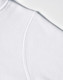 A close-up of a white fleece hoodie featuring a curved shoulder seam and a logo.