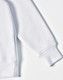 A white fleece hoodie featuring a close front design and contrast stitching on the cuff. The garment has a logo.