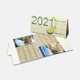 A desk calendar featuring a green design, displaying the year 2021 and several months in a fold-out format.