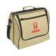 A beige picnic basket with a black trim and a front pocket, featuring a logo.