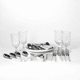 A picnic set features white-handled cutlery, glass tumblers, and serving platters on a white background.