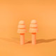 A pair of peach silicone earplugs on an orange background, designed for noise reduction, featuring a simple and smooth shape.