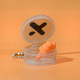 A clear keychain case containing orange silicone earplugs, set against an orange background.