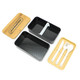 A two-layer lunch box with a bamboo lid, featuring a black inner compartment and a tray with cutlery.