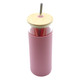 A drink bottle in a soft pink colour with a bamboo lid and metal straw, featuring a clear body.
