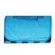 A blue picnic blanket with a foldable design and a handle for easy transport. It features a black and blue patterned underside.