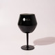 A black detachable wine glass with a sleek finish and a logo on the front.