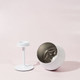 A white Shiraz detachable wine glass, featuring a removable stem and a metallic interior, set against a pale background.