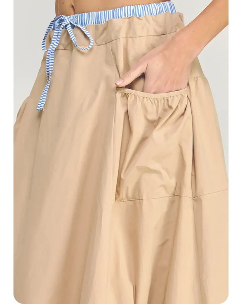 Trick Puff Parachute Skirt, featuring a balloon hem, drawstring waist, and lightweight neutral cotton