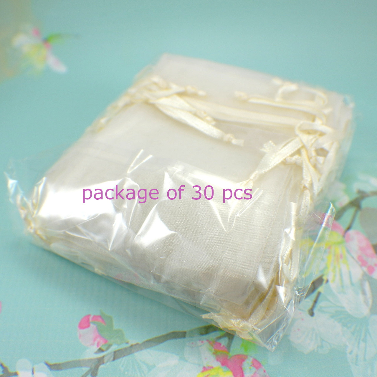 30 piece package of ivory sheer organza drawstring flat jewelry pouches