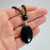 Oval black obsidian pendant necklace with slender gemstone strand