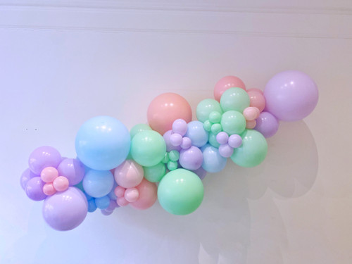 Pastel balloon garland display arch installation for birthday parties and baby showers