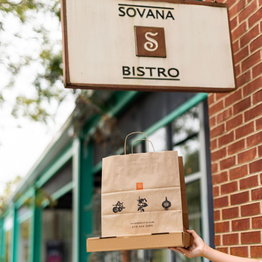 A custom kraft paper shopping bag for a restaurant and takeout orders.