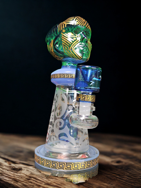 Clear glass dab rig with water chamber, quartz banger, and mouthpiece, designed for vaporizing cannabis concentrate