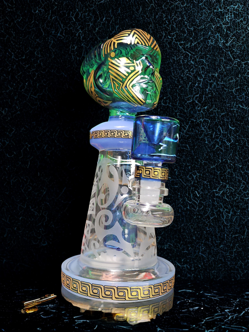 Clear glass dab rig with water chamber, quartz banger, and mouthpiece, designed for vaporizing cannabis concentrate