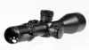 Element Optics Titan 5-25x56 FFP riflescope with an APR-1D MRAD reticle. We get a close look at the objective lens, the adjustment turrets, and the magnification ring. The large dial in the middle is the elevation adjustment, and the smaller dial towards the eyepiece is likely the magnification adjustment, with the numbers indicating the level of zoom. MRAD on the reticle stands for milliradians, which is a unit of angular measurement used for ballistics and rangefinding. The green tint on the lens suggests anti-reflective coatings, which improve light transmission and reduce glare for a clearer image. The overall design conveys robustness and precision, characteristics valued in high-performance long-range scopes.