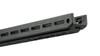 This image showcases the end of the forend of the MDT ACC Elite Chassis System designed for the Remington 700 rifle. It highlights the M-LOK slots, which are used for attaching various accessories such as bipods, slings, and rail sections. The design is optimized for modularity and customization, allowing shooters to tailor their setup to their specific needs. The angled end of the forend, often called a barricade stop, is useful for stabilizing the rifle against various surfaces when shooting in different positions. The MDT ACC chassis is favored by precision shooters for its adaptability and robust construction, which aid in enhancing shooting performance.