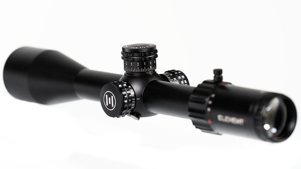 Element Optics Helix 6-24x50 SFP rifle scope with an EHR-1C MOA reticle. The optic is designed with a second focal plane (SFP) layout, which keeps the reticle size consistent across the magnification range. It is set against a blurred white background, highlighting its sleek black body, large adjustment turrets with MOA markings, and multi-coated lens that reflects a spectrum of light, indicating high-quality optics. This scope is suitable for hunters and precision shooters who require detailed reticle for accurate shot placements. The branding and model details are clearly visible on the scope, catering to customers who value precision engineering and quality construction in their optics.