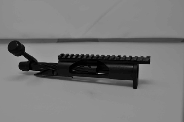 Profile view of the Kelbly Atlas Tactical short action bolt assembly in black nitride finish, designed for .308 caliber. This assembly features a 1.35-inch round right-hand bolt with spiral fluting and a tactical knurled knob. It supports magazine loading and standard right-side ejection. Additionally, it's equipped with a Picatinny rail providing a 20 MOA elevation and a securely pinned lug, offering robustness and precision for tactical shooting scenarios.