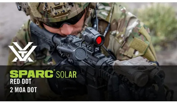 In the image you've uploaded, there's a SPARC SOLAR red dot sight from Vortex Optics. It's a 1x optic, meaning it doesn't magnify the image, and features a 2 MOA (Minute of Angle) dot reticle, which is a common size for precise aiming while still being quick to acquire. The name suggests it incorporates solar power, which is often used to extend the battery life of electronic sights. The optic is shown mounted on a rifle being used by a person who appears to be in military or tactical gear, emphasizing the red dot's application in tactical situations.